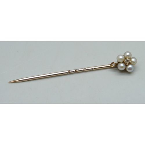 1025 - A yellow metal and pearl stick pin with diamond centre, 1.6g, cased