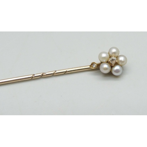 1025 - A yellow metal and pearl stick pin with diamond centre, 1.6g, cased