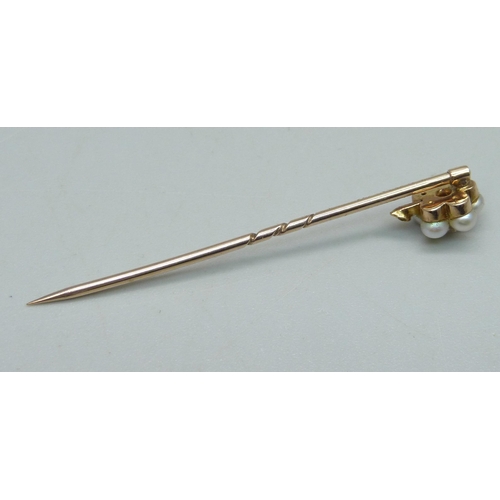 1025 - A yellow metal and pearl stick pin with diamond centre, 1.6g, cased