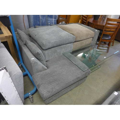 1563 - A grey jumbo cord left hand facing corner sofa and footstool plus one other footstool