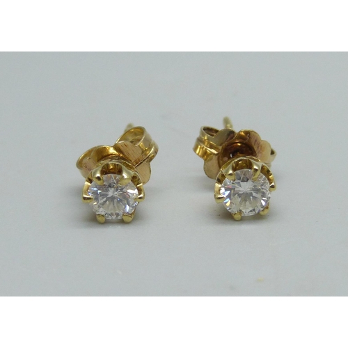 1029 - A pair of 18ct gold and diamond stud earrings, total 0.60 carats, 1.3g