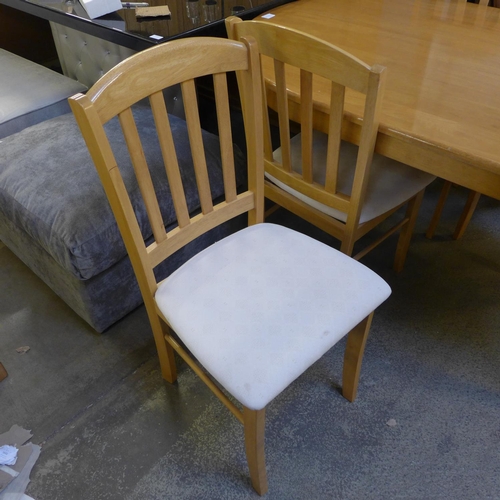 1590 - A beech dining table and four chairs