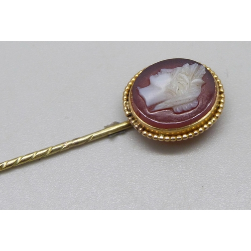 1034 - A yellow metal and carved cameo stick pin, 3.7g, cased