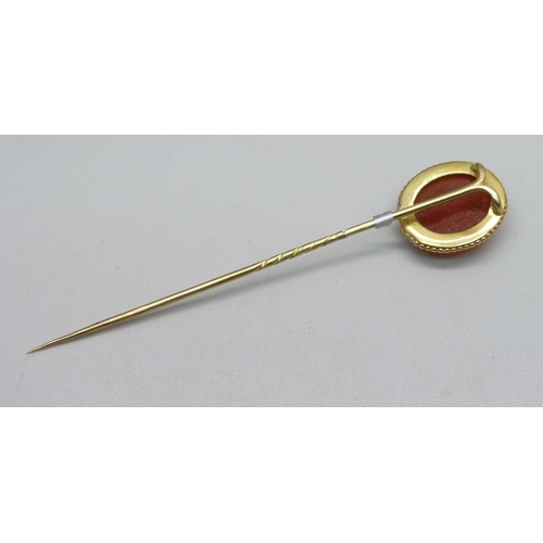 1034 - A yellow metal and carved cameo stick pin, 3.7g, cased