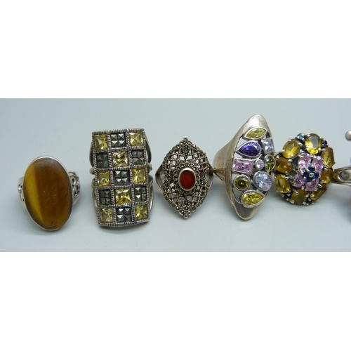 1056 - Ten chunky large silver rings set with topaz, garnet, zircon, tigers eye, etc., up to 35mm, 96g