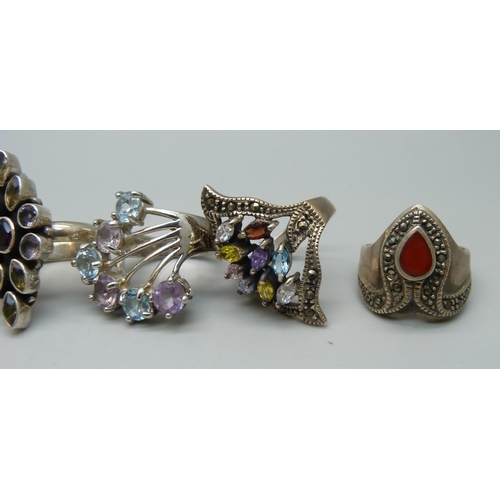 1056 - Ten chunky large silver rings set with topaz, garnet, zircon, tigers eye, etc., up to 35mm, 96g