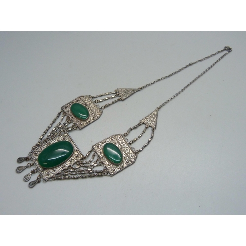 1067 - A green stone set Eastern necklace, approximately 43cm