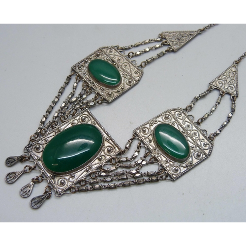 1067 - A green stone set Eastern necklace, approximately 43cm