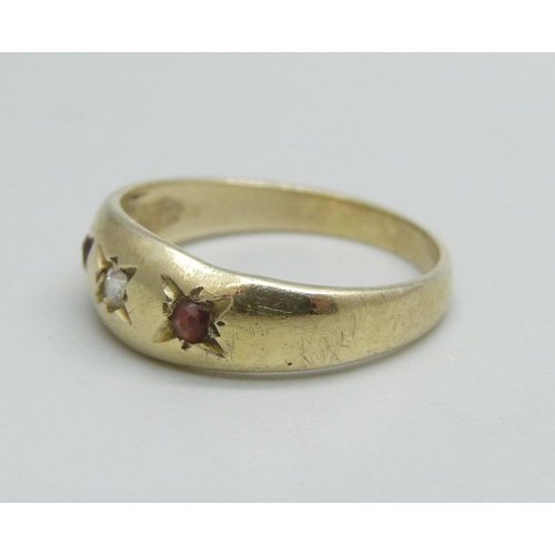 1098 - A 9ct gold ring set with two garnets and a white stone, 1.7g, J/K