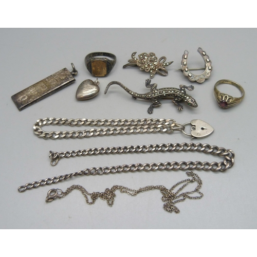 1103 - A collection of silver jewellery including a 1977 ingot, a lizard brooch, two rings, a curb chain br... 