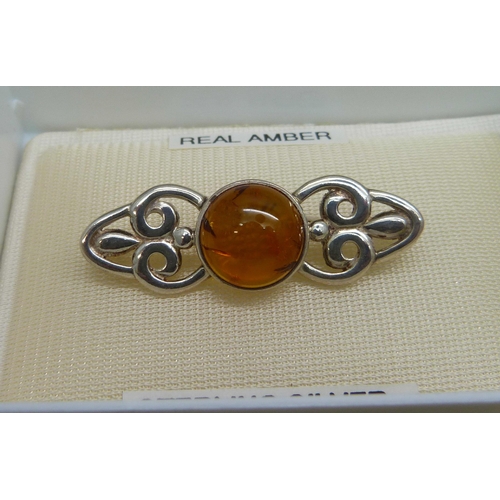 1104 - A silver and amber set brooch, and three pairs of faux pearl screw back earrings with silver mounts