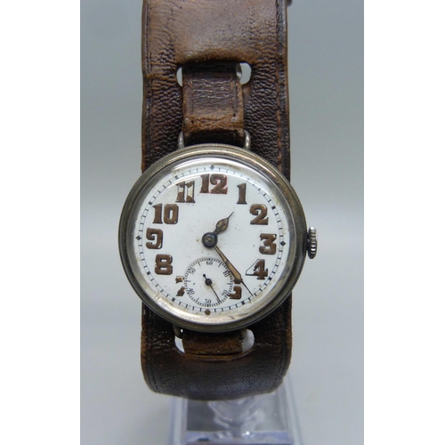 1106 - A silver cased trench watch on a leather strap