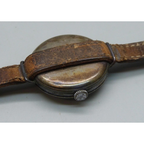 1106 - A silver cased trench watch on a leather strap