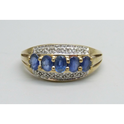 1129 - A 9ct gold ring set with five sapphires and 14 small diamonds, 2.6g, T