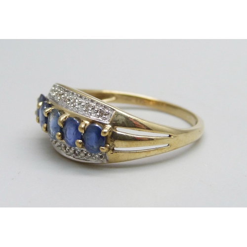 1129 - A 9ct gold ring set with five sapphires and 14 small diamonds, 2.6g, T