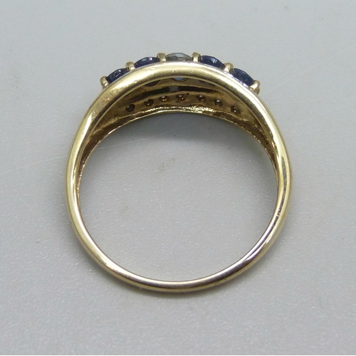 1129 - A 9ct gold ring set with five sapphires and 14 small diamonds, 2.6g, T