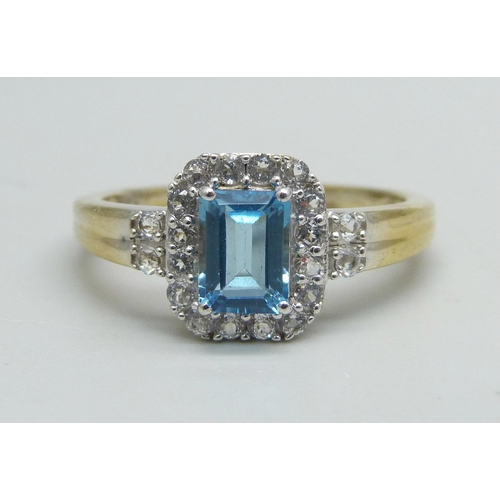 1130 - A silver gilt, Swiss blue and white topaz ring, U