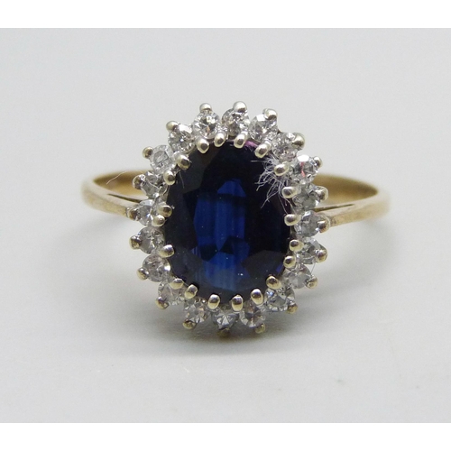 1138 - A 9ct gold ring set with a central sapphire and diamond halo, 2.7g, Q