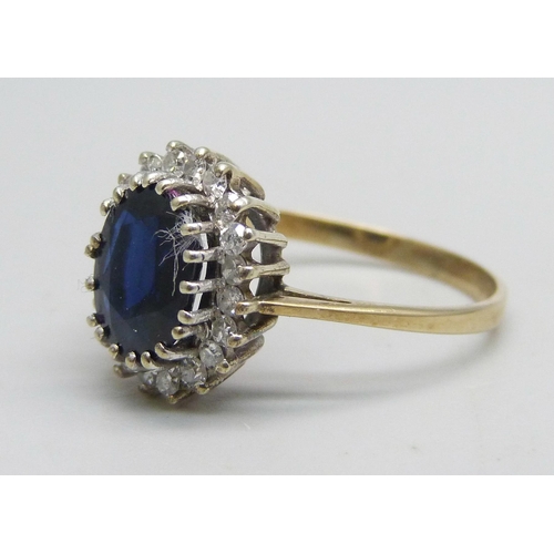 1138 - A 9ct gold ring set with a central sapphire and diamond halo, 2.7g, Q