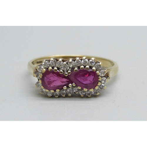 986 - A 9ct gold ring set with two rubies and an outer row of diamonds, 2.3g, N