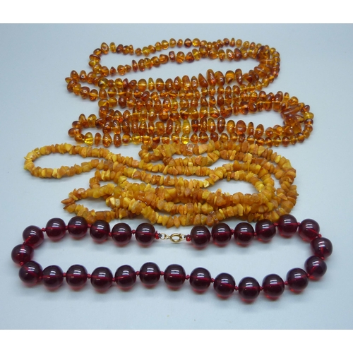 997 - A collection of four amber and amber style necklaces