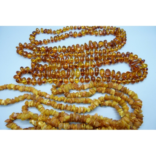 997 - A collection of four amber and amber style necklaces