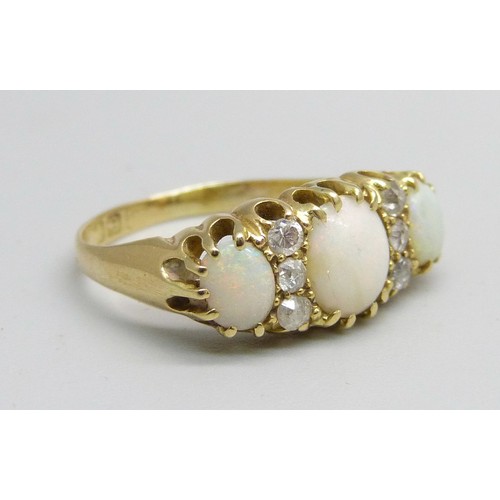 1042 - An 18ct gold three stone opal and diamond ring, 3.2g, M