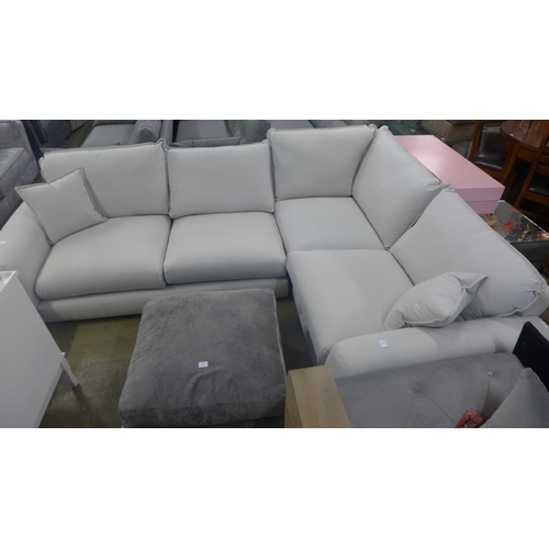 1584 - A putty fabric upholstered right hand facing corner sofa, handling marks/damage