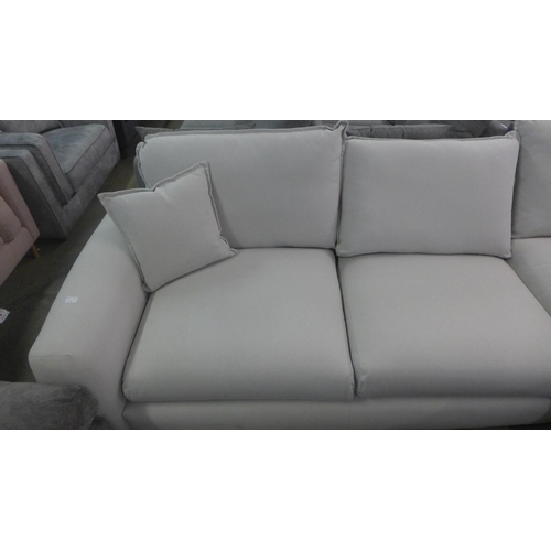 1584 - A putty fabric upholstered right hand facing corner sofa, handling marks/damage