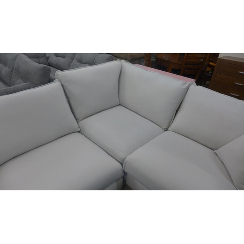 1584 - A putty fabric upholstered right hand facing corner sofa, handling marks/damage