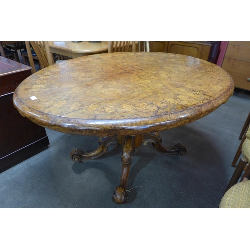 101 - A Victorian inlaid walnut oval tilt-top centre table