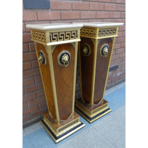 102 - A pair of Italian style simulated walnut, parcel gilt and faux marble pedestals