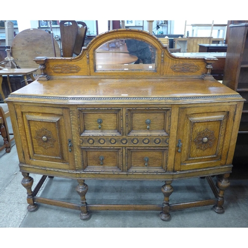 109 - An early 20th Century carved oak mirroback sideboard