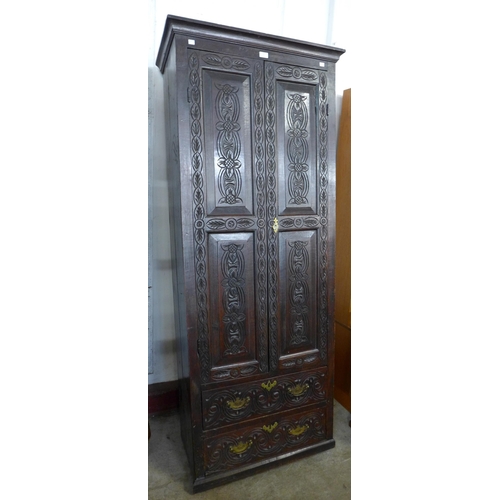 120 - A George III carved oak two door housekeeper's cupboard