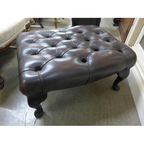 127 - A chestnut brown leather Chesterfield footstool