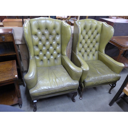 135 - A pair of Queen Anne style mahogany and green leather wingback armchairs