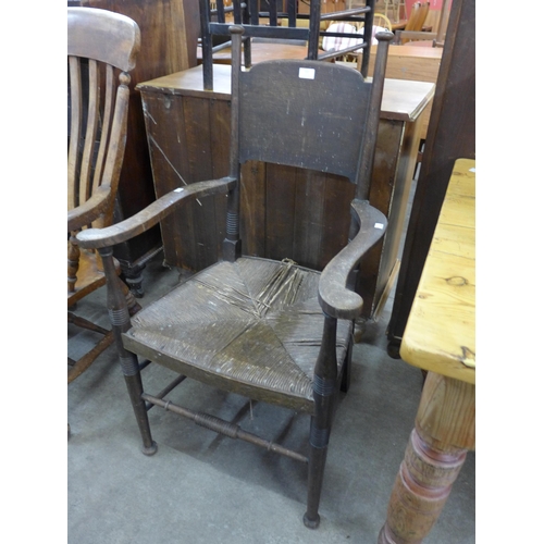 137 - A Liberty & Co. ash rush seated elbow chair, designed by William Birch