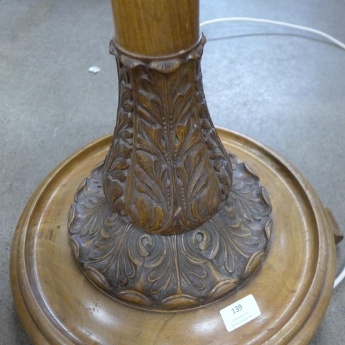 139 - A carved walnut standard lamp