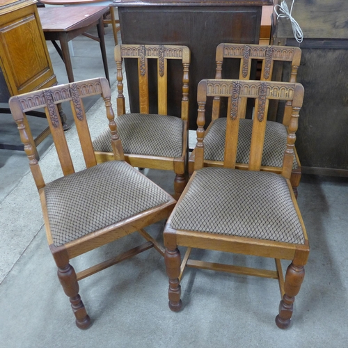 142 - A set of four carved oak dining chairs