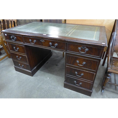 143 - A mahogany and green leather topped pedestal desk