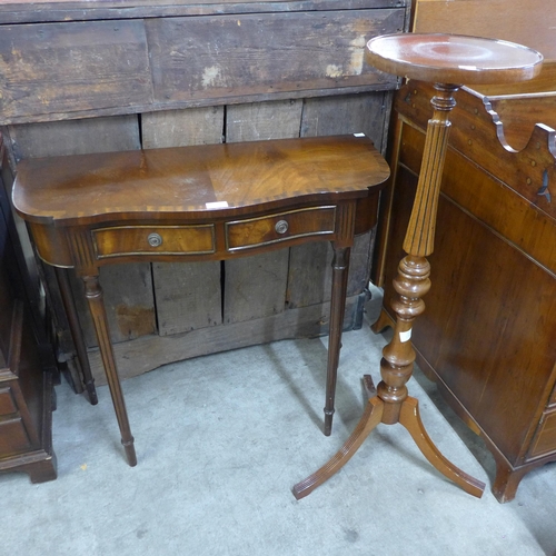 149 - A mahogany serpentine two drawer hall table and a torchere