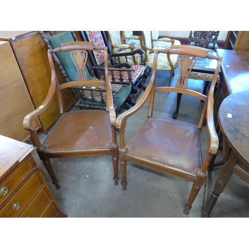 152 - A pair of French mahogany elbow chairs