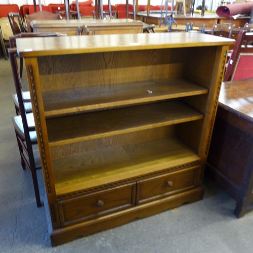 157 - A carved oak open bookcase