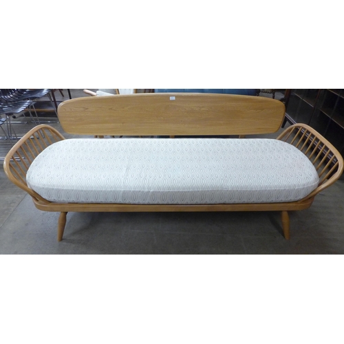 18 - An Ercol Blonde ash and beech 355 model studio couch. Purchased by the vendor from Hopewells, Nottin... 