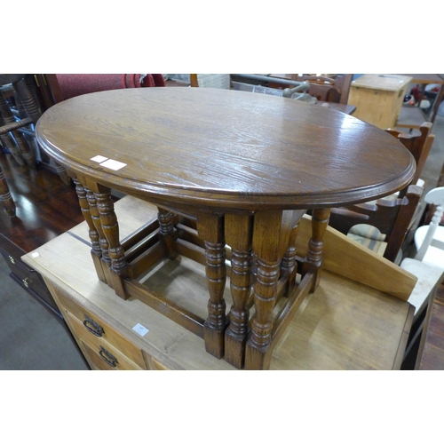 188 - An oval oak nest of tables