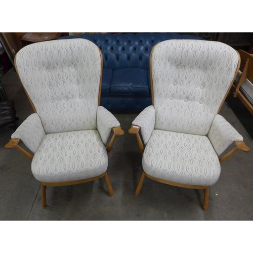 19 - A pair of Ercol Blonde beech Evergreen armchairs. Purchased by the vendor from Hopewells, Nottingham... 