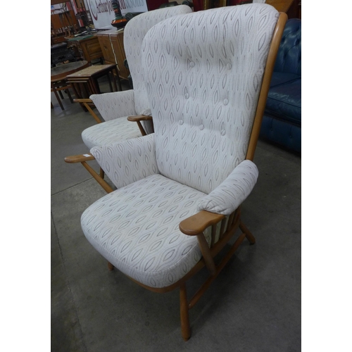 19 - A pair of Ercol Blonde beech Evergreen armchairs. Purchased by the vendor from Hopewells, Nottingham... 