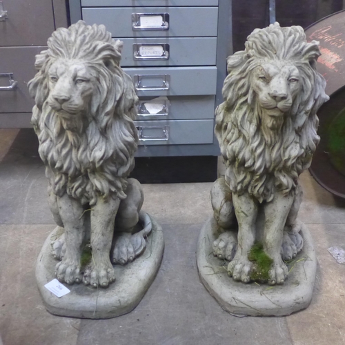 266 - A pair of concrete garden figures of seated lions