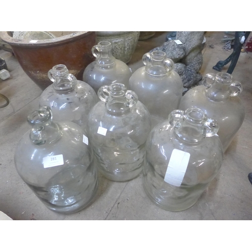 281 - A set of six glass demi-Johns and another