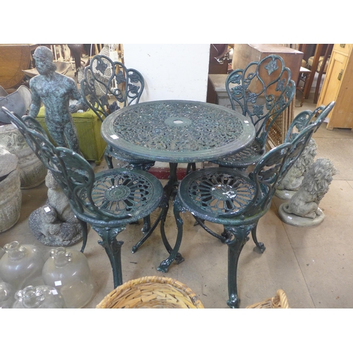 284 - A painted cast alloy garden table and four chairs